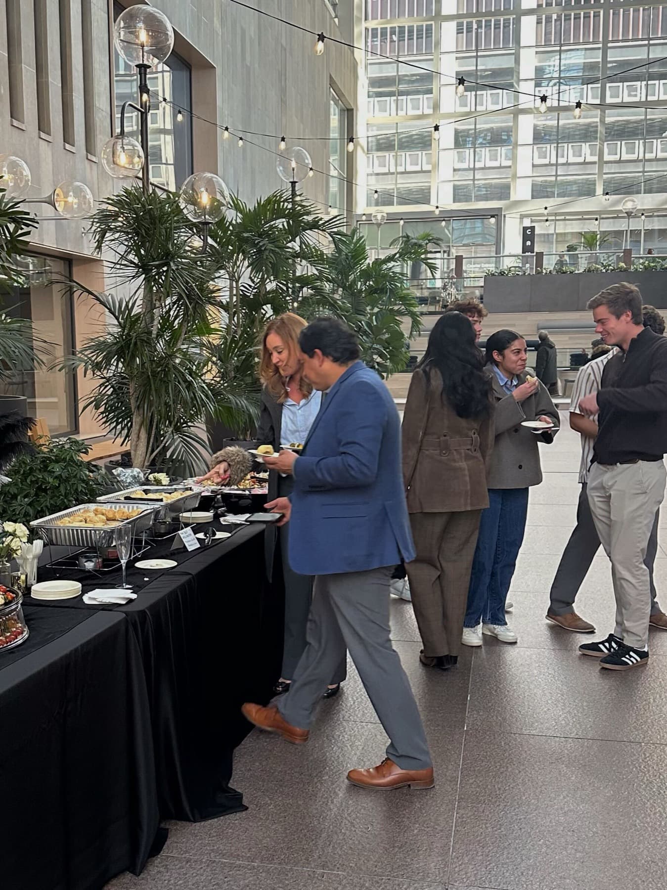 Catered atrium reception under string lights